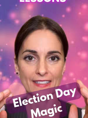 A woman with brown hair and fair skin smiles while holding a purple banner with text overlaid on a blurred pink and purple background. The banner includes the words "Election Day Magic."