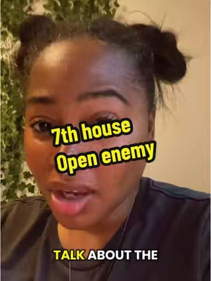 A close-up shot featuring a woman of color. She has dark hair styled in small buns on top of her head. The background is a blurred interior setting with a glimpse of greenery. Overlay text in a yellow box covers a section of her face.