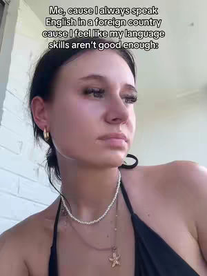 A woman with dark hair and a black top looks off to the side with a slightly pensive expression. Text overlays the image in a clear, sans-serif font.