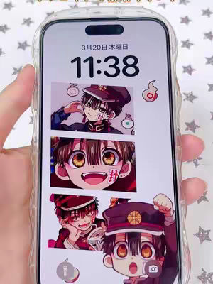A person's hand is holding a phone displaying a screen with the time and date at the top. The content is anime art depicting the character Hanako-kun from the anime series 'Toilet-Bound Hanako-kun'. The anime character art is arranged in a vertical collage consisting of three different depictions. The screen is encased in a clear phone case.