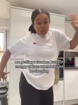A woman with her hair up is in a kitchen, looking amazed. Text at the bottom says: me getting a random burst of energy at 2am when I should be sleeping.