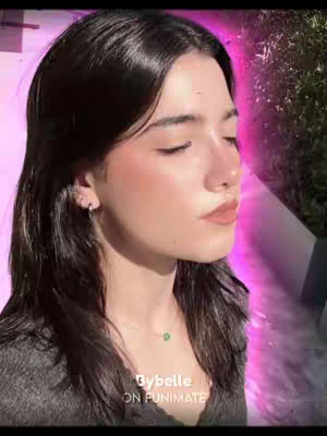 A close-up shot of a person with dark hair, angled slightly to the side, with eyes closed and a soft, neutral expression. The background fades to pink, and the overlay text identifies the creator.