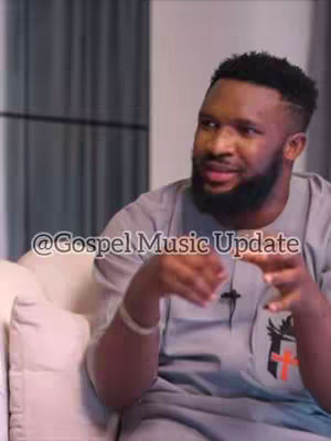 A man with a beard is seated and gesturing with his hands. The background contains a blurred curtain. The text overlay reads '@Gospel Music Update'.