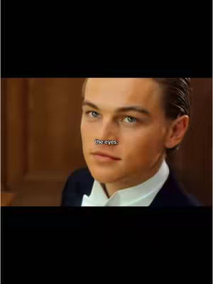 The cover image shows a close-up of Leonardo DiCaprio's face from the movie Titanic, in which he is looking at the viewer staring into the shot. Superimposed is some text in a black rectangular section. Background is a wooden wall.