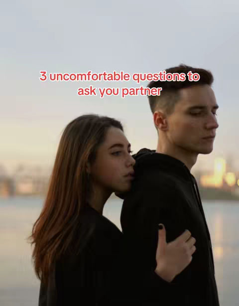 The cover photo features a young woman and a young man embracing each other. The woman is leaning on the man's back on a blurred background showing a blurred ocean and sky.  A text overlay states "3 uncomfortable questions to ask you partner."