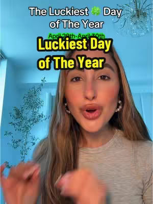 A woman with long, light-brown hair is centered in the frame, her face brightly lit with soft, natural lighting. She's making a surprised expression, lips slightly parted. Over her image at the top of the frame are two text boxes. To the left of her are a few green decorative plants.