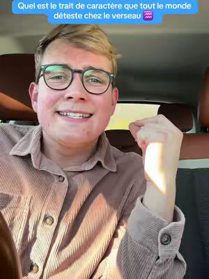 The cover image features a young man in a car, with text overlayed. The man is wearing glasses and a button-down shirt, smiling towards the camera. There is text in a speech bubble at the top left. The seat behind him is brown.