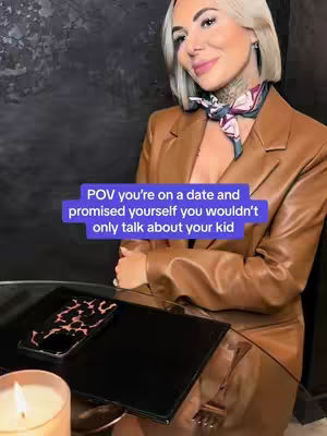A woman with blonde hair and a blazer sits at a table. There is overlaying text on the image.