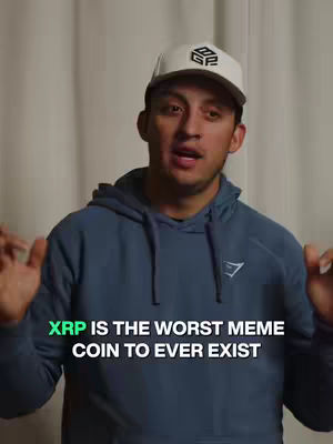A man in a blue hoodie and a white baseball cap with a logo is centered in the frame. Text overlayed on the image reads: 'XRP IS THE WORST MEME COIN TO EVER EXIST'. The background is blurred, likely a plain wall.
