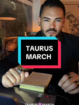 A man with a trimmed beard and dark hair is facing the camera. He is wearing a black shirt and has a ring on his finger. There is text overlayed in a rectangular shape. The background has a blurred indoor setting. The overall composition suggests a personal moment.