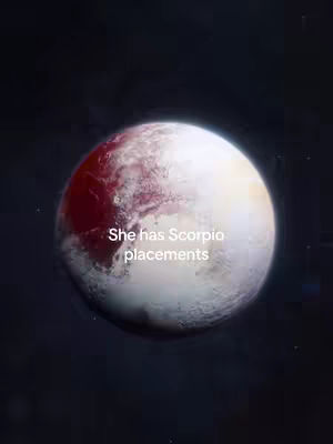 The image displays a large sphere resembling a planet, possibly Pluto, set against a dark, space-like background. The planet has a combination of reddish-brown and white areas. Text overlaid on it reads 'She has Scorpio placements'.