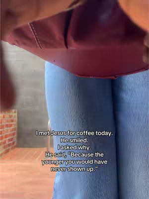 The image features a low-angle shot with the focus on the lower half of the body, with a woman in light blue jeans and parts of a reddish-burgundy top appear at the top. The background includes a brick wall and a grey wall, both out of focus. Text overlays, written in a readable font, are present across the image, detailing a personal narrative of meeting Jesus for coffee.