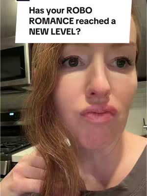 A close-up shot of a woman with red hair is shown. She has her hair parted to the side with strands falling around her face in soft curls. She has clear skin and is looking directly at the camera with a slightly pursed expression. Above her, a text overlay in a white box reads, “Has your ROBO ROMANCE reached a NEW LEVEL?”, a caption added to the image.
