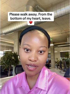 A woman with a black hairband in a pink shirt is centered, with text over her head, against the backdrop of an office setting.