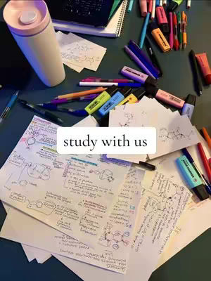 The cover image shows a top-down view of a desk covered in study materials. There are several sheets of paper covered in handwritten notes, diagrams, and chemical structures. A variety of pens, highlighters, and markers are scattered across the surface. A large, white and pink water bottle is also visible. The text overlayed is 'study with us'.
