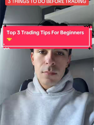 A man in a gray hoodie is centered in a selfie-style shot. Above his head is a red banner with white text that reads 'Top 3 Trading Tips For Beginners,' with a small gold gem graphic to the left. A white shelf can be seen in the background.