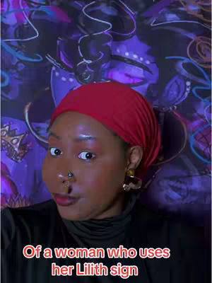 A woman with a red headscarf poses in front of a patterned purple background. The woman has a nose ring and bold makeup. Text is overlaid on the image, reading 'Of a woman who uses her Lilith sign'.