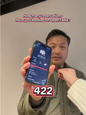 A man holds a smartphone displaying the OpenTable app screen. Text overlays on the image ask the viewer how many reservations they've booked. A red and white text graphic at the bottom of the image displays the number 422.