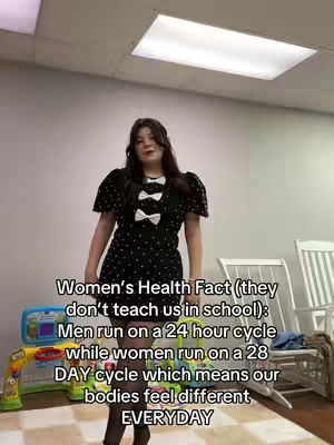 A woman in a black polka dot dress stands in what appears to be a storage room, with baby toys in the background. Text overlayed on the image discusses women's health facts.