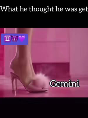 The image shows a woman's leg and foot in a pink setting. The woman is wearing a high-heeled shoe with a white furry strap. The shoe and her foot are the primary focus, with only a portion of her leg visible. The background is a blurred pink, suggesting a room or studio. The words “Gemini” in a white font with a black outline are on the bottom right corner and text is displayed at the top of the image. Emojis like the Gemini symbol ♊️ , a devil face 😈 and a purple heart 💜 are placed at the top left.