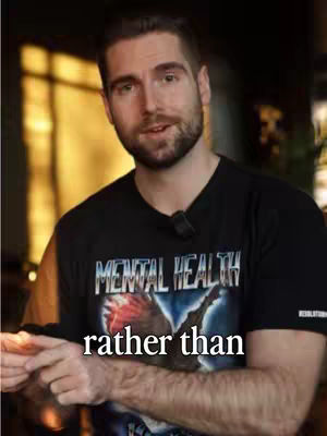A man wearing a dark t-shirt with a graphic and the words 'MENTAL HEALTH' is the central focus, set against a subtly blurred background. The hook text 'rather than' is overlaid at the bottom. The composition features a balanced and straightforward presentation.