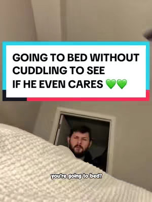 A man in a slight close-up, peering out from under a white blanket. Above him is a text overlay with a blue backdrop, and the text in prominent, bold, white font. Below the text are two green heart emojis. Further below the blanket, a face is visible, with text overlaid with an even more transparent and smaller font.