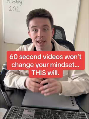 The cover image features a man sitting at a desk talking directly at the camera with a microphone to his left. A red banner in the foreground covers a portion of the man's face, with text that describes the video's topic.