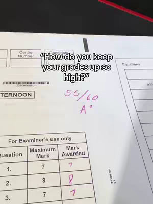 The image is a close-up of a written exam paper. The paper is white with printed sections for entering details. In the top section is written the question: How do you keep your grades up so high?