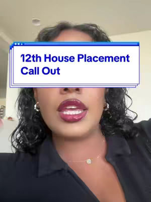 A woman with dark curly hair and a dark top is centered in the frame, her face prominent. She has full, glossy lips and is wearing hoop earrings and a delicate necklace. A text overlay in a blue and white box covers her forehead, while the background appears to be an interior space.