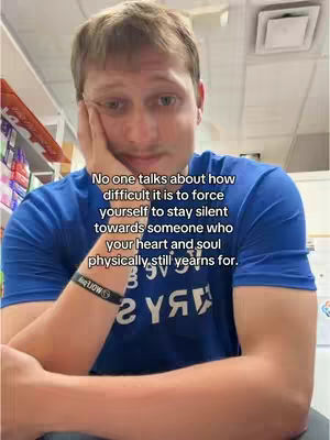 The cover image features a young man in a blue t-shirt with text overlaid. The man is fair-skinned with short, light-brown hair and a slightly somber expression.  He is resting his head on his left hand, with his elbow bent. The background appears to be an interior likely within a store due to the presence of products on shelves.. The text overlay includes multiple lines of text describing difficult feelings.