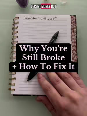 The image shows a notebook with the question 'why am I still broke?' written on a lined page. A black pen is placed diagonally across the notebook, with part of the pen resting on the page. A black rectangle overlaid with white text reading 'Why You're Still Broke + How To Fix It' is placed over the notebook. A hand is seen in the bottom-right corner of the image holding the notebook.