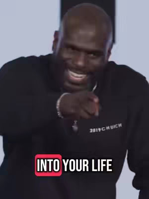Cover image showing a bald Black man with a beard smiling and pointing his index finger towards the viewer. He wears a black long-sleeved shirt. Overlay text in a red box says, INTO YOUR LIFE.