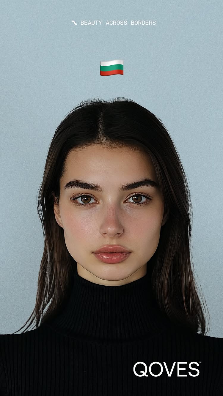 A close-up portrait of a woman with dark hair and light skin. She is looking directly at the camera with a neutral expression. Her lips are lightly colored, and she is wearing a black turtleneck. The background is a solid, light blue color. There is text at the top and the bottom of the image.