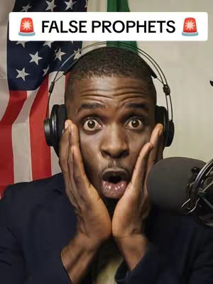 A man with dark skin, wearing headphones, has a look of shock on his face, with hands on his cheeks. Behind him is a partial view of the American and Nigerian flags.