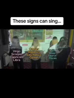 The cover image shows a group of people, likely women, standing in front of a backdrop. Text overlays identify zodiac signs and phrases such as "These signs can sing...". The composition is somewhat blurred, with visible text and figures.