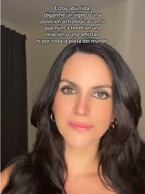 A woman with long black hair and light makeup is positioned in the center of the frame. The backdrop is simple and plain with what appears to be a dark curtain on the right side. Text in Spanish is layered at the top, suggesting a question or prompt about astrology.