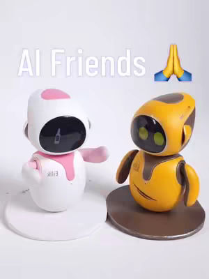 The image features two robotic figures, one white with pink accents and the other yellow, against a white background. The white robot has a pink head and arm, arms outstretched, and a black screen. The yellow robot has a black screen and a rounded body. The image makes a sign of prayer with blue and yellow colors overlaid in the image