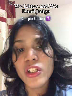 A selfie-style cover image featuring a young woman in a close-up shot. Text overlays at the top of the image read "We Listen and We Don't Judge" and "Scorpio Edition" with a Scorpio symbol. The woman has dark hair, and is looking directly at the camera with her mouth open.