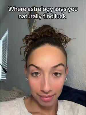 The cover image features a close-up selfie of a woman with light skin and light brown hair pulled up. She has a slightly smiling expression with her brown eyes focused towards the camera. Text overlayed at the top says, "Where astrology says you naturally find luck."