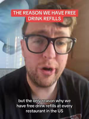 A man with glasses, wearing a black shirt, is speaking directly to the camera. Above him is a red banner with white text.