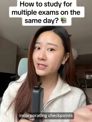 A young woman with long brown hair and a white sweater is holding a microphone and speaking directly to the camera. Text overlays at the top read, "How to study for multiple exams on the same day?" In the background, a soft focus reveals a nondescript interior.