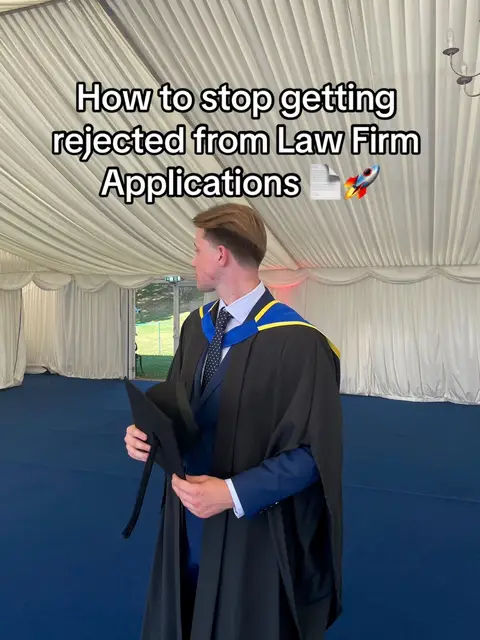 A man in a graduation gown is standing in front of a white tent. The background includes blue flooring. Text overlays read "How to stop getting rejected from Law Firm Applications".