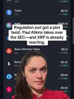 A woman is centered, facing the camera with a serious expression, with a background of a crypto app interface showing various cryptocurrency stats. Above her, a white rectangle displays the text overlay.