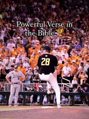 A baseball pitcher in a black and gold uniform, number 28, is in mid-pitch on the mound. The background is a crowded stadium filled with fans wearing orange and white. Text overlay reads 'Powerful Verse in the Bible' with a trophy icon.