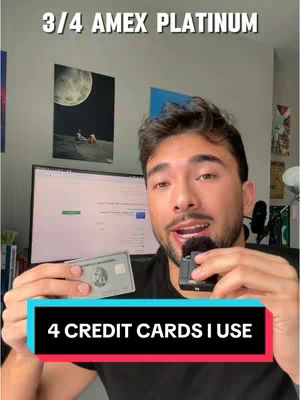 A young man with dark hair and a beard is holding a credit card and a microphone in front of a background. A red bar overlay at the bottom with the text: "4 CREDIT CARDS I USE" over a gradient background. The image is well-lit, with good contrast.