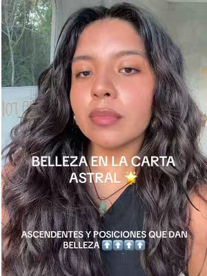 A woman with long, dark, wavy hair is the focal point of the image, set against an outdoor backdrop. The text overlay includes the words "Belleza en la Carta Astral," with supplementary text below. The composition is a close-up shot focusing on the woman's face and upper body.