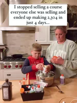 The cover image shows a woman and a young boy in a kitchen setting. The woman, positioned to the right, is holding an orange and looking down with a slight frown. The boy, to the left, is focused on a bowl, working with some materials. The background features kitchen elements, including a stove, cabinets, and various supplies on the counter. Rectangular text overlay is at the top the image.