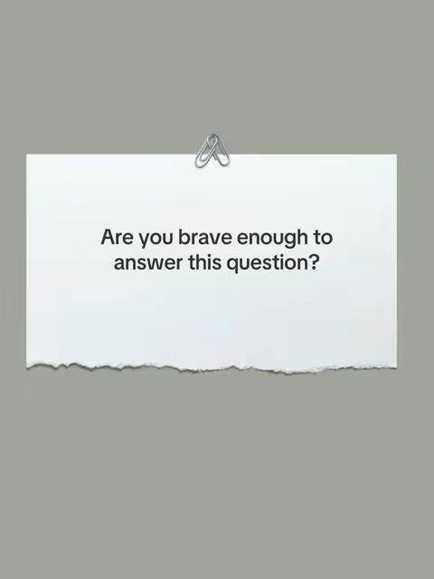 A piece of white paper with a torn bottom edge is centered against a gray background. The paper is held in place with a silver paper clip at the top, and it features the question, 'Are you brave enough to answer this question?' in black text.