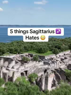 An aerial view shows an ancient stone structure with a few trees scattered around. In the back, a body of water and some sky can be seen. The visible overlay text displays "5 things Sagittarius Hates".