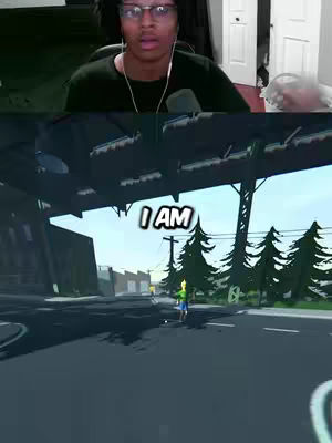 The cover image is split horizontally. The top half features a young man with glasses looking at the camera with a concerned expression. The bottom half shows a scene from a video game; a character is walking down a road, with text overlaid that says, “I AM”. The colors skew toward cool tones, especially in the game scene.